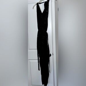 Sequined black halter jumpsuit that ties around neck. Size S. 100% polyester.